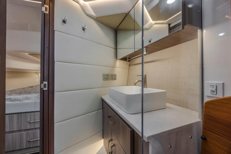  Yacht Photos Pics Modern bathroom interior of 2022 Regal 36 Grande Coupe yacht, featuring sleek design and fixtures.