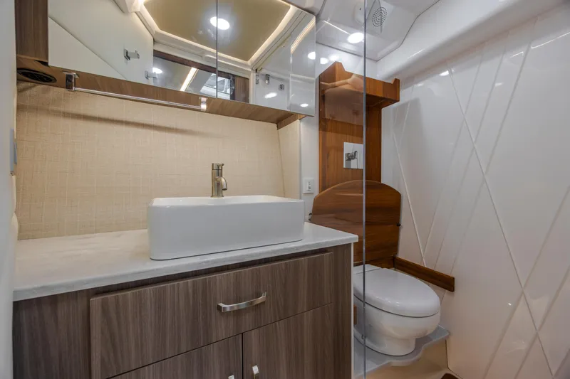  Yacht Photos Pics Luxurious bathroom in 2022 Regal 36 Grande Coupe yacht with modern fixtures and elegant design.