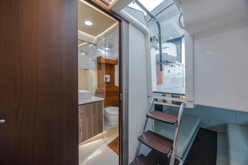  Yacht Photos Pics Interior of 2022 Regal 36 Grande Coupe yacht, featuring a modern bathroom and ladder access.