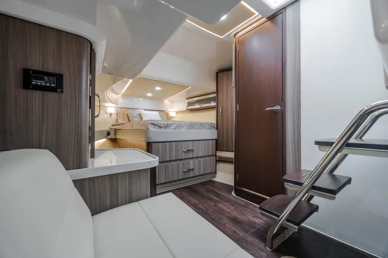 Yacht Photos Pics Luxurious interior of 2022 Regal 36 Grande Coupe yacht with modern furnishings and cozy bed.