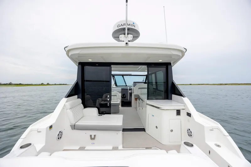  Yacht Photos Pics 2022 Regal 36 Grande Coupe yacht interior with seating and water view.