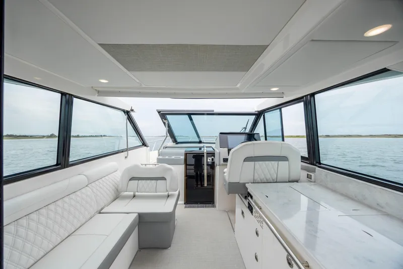  Yacht Photos Pics Interior of 2022 Regal 36 Grande Coupe yacht with luxurious seating and panoramic windows.