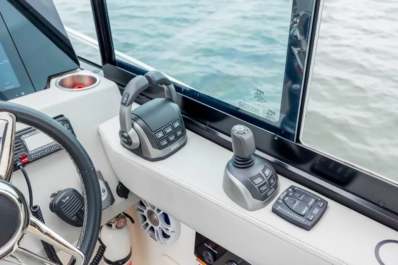  Yacht Photos Pics 2022 Regal 36 Grande Coupe helm controls with joystick and throttle near water.