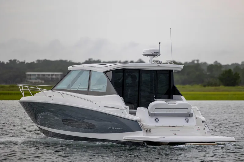 Yacht Photos Pics 2022 Regal 36 Grande Coupe cruising on a calm waterway.
