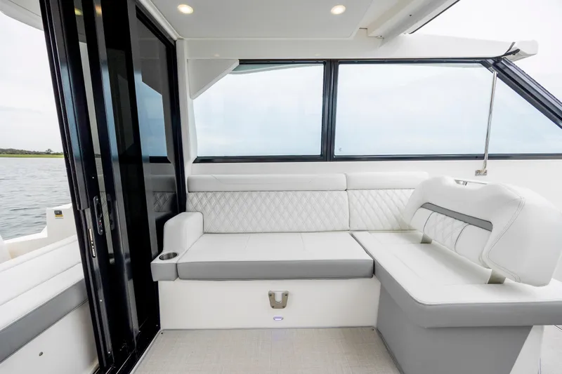  Yacht Photos Pics Interior of 2022 Regal 36 Grande Coupe with elegant white seating and large windows.
