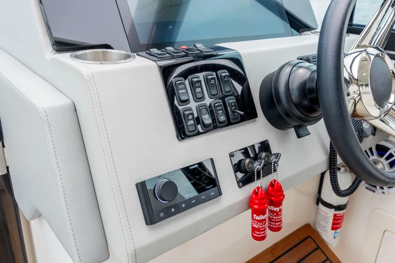  Yacht Photos Pics Control panel of 2022 Regal 36 Grande Coupe boat with steering wheel and switches.