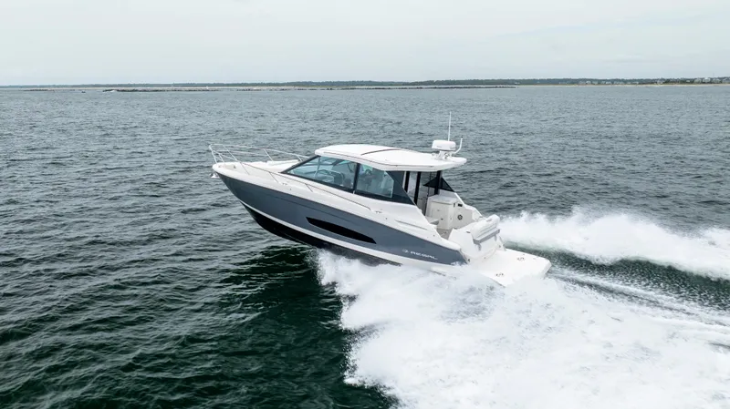  Yacht Photos Pics 2022 Regal 36 Grande Coupe cruising on open water, showcasing sleek design and performance.