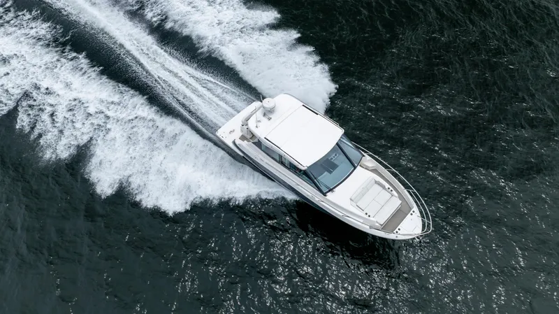  Yacht Photos Pics 2022 Regal 36 Grande Coupe cruising on open water, aerial view.