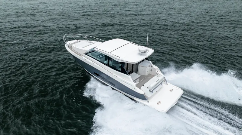  Yacht Photos Pics 2022 Regal 36 Grande Coupe cruising on open water, showcasing sleek design and performance.