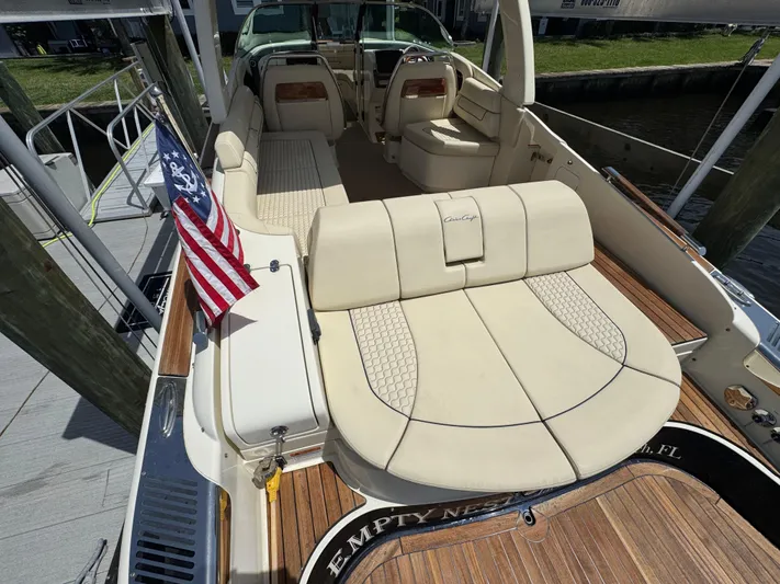  Yacht Photos Pics 2020 Chris-Craft Launch 31 GT boat interior with American flag, luxury seating, and wooden deck.
