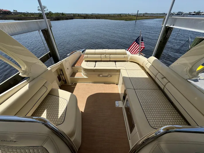  Yacht Photos Pics 2020 Chris-Craft Launch 31 GT boat interior with beige seating and American flag.