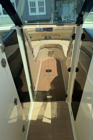  Yacht Photos Pics 2020 Chris-Craft Launch 31 GT interior with beige seating and carpeted flooring.