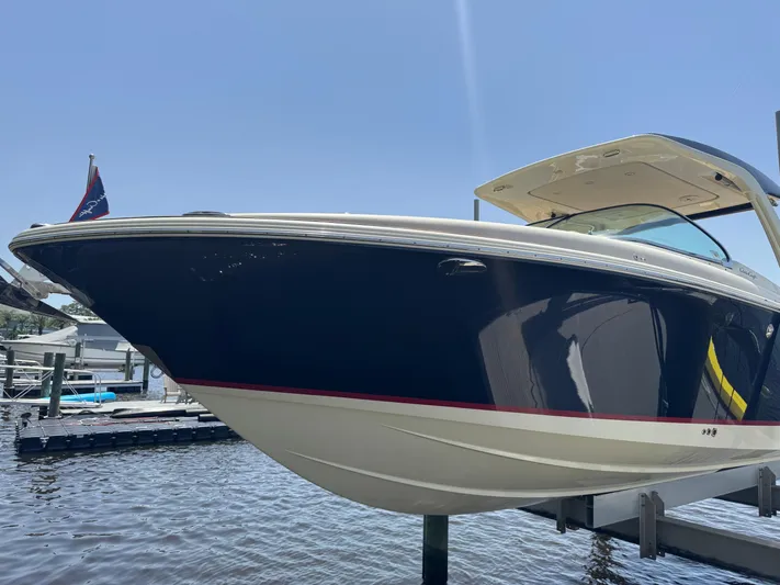  Yacht Photos Pics 2020 Chris-Craft Launch 31 GT boat docked, showcasing sleek design and elegant navy hull.