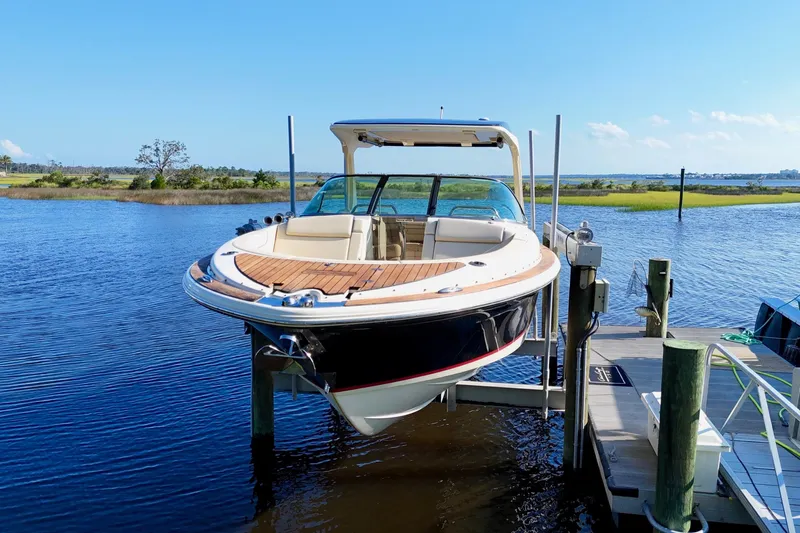  Yacht Photos Pics 2020 Chris-Craft Launch 31 GT boat docked on a lift by the water.
