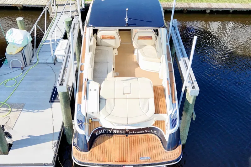  Yacht Photos Pics 2020 Chris-Craft Launch 31 GT boat docked, featuring elegant seating and teak flooring.