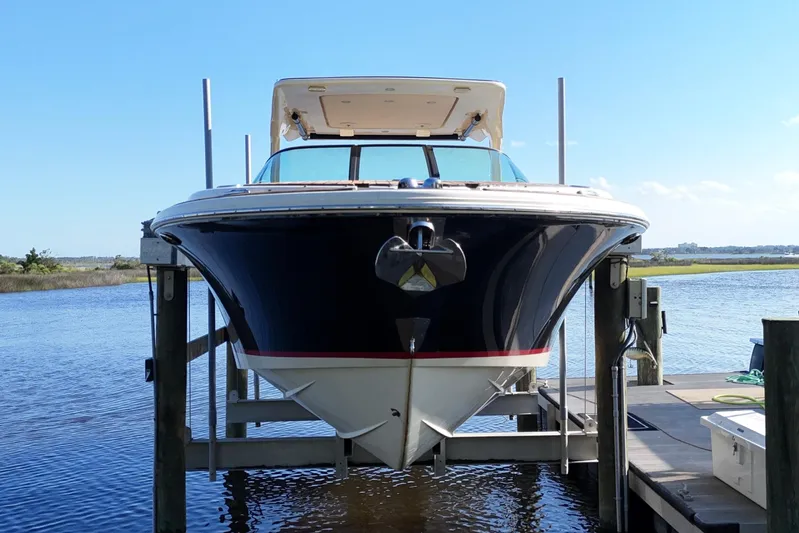  Yacht Photos Pics 2020 Chris-Craft Launch 31 GT boat docked on a lift by the water.