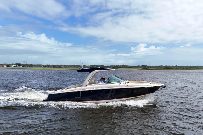  Yacht Photos Pics 2020 Chris-Craft Launch 31 GT cruising on a calm lake under a partly cloudy sky.