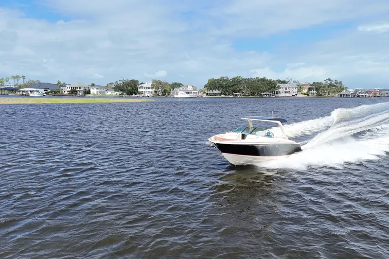  Yacht Photos Pics 2020 Chris-Craft Launch 31 GT speeding on a scenic lake with waterfront homes.