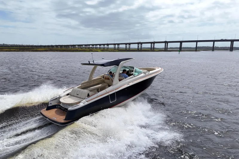  Yacht Photos Pics 2020 Chris-Craft Launch 31 GT cruising on open water near a bridge.