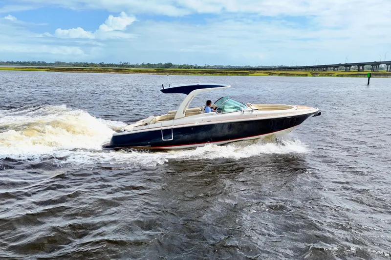  Yacht Photos Pics 2020 Chris-Craft Launch 31 GT cruising on a sunny day, showcasing sleek design and performance.