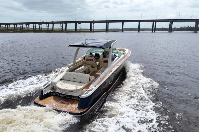  Yacht Photos Pics 2020 Chris-Craft Launch 31 GT cruising on water near a bridge.