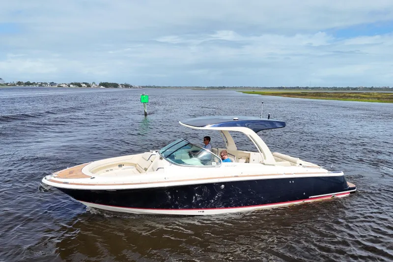  Yacht Photos Pics 2020 Chris-Craft Launch 31 GT boat cruising on open water under a clear sky.