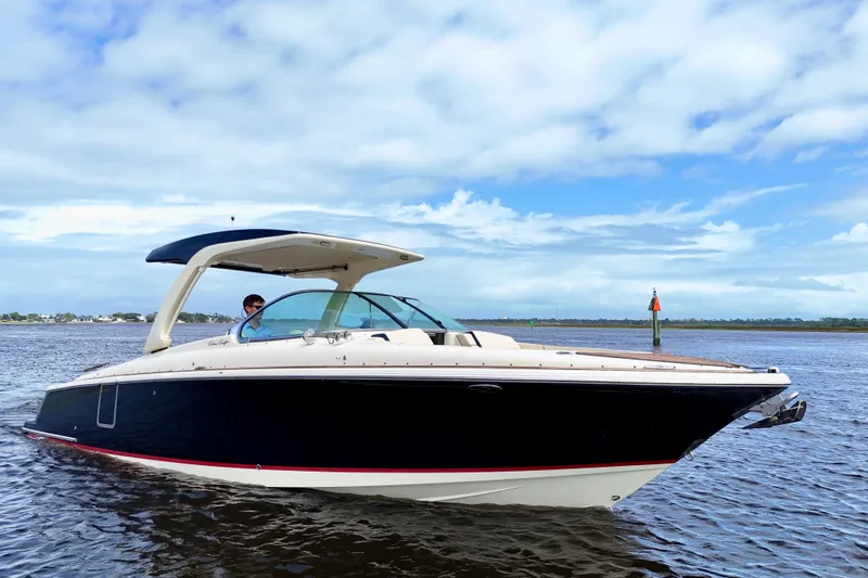  Yacht Photos Pics 2020 Chris-Craft Launch 31 GT boat cruising on open water under a blue sky.