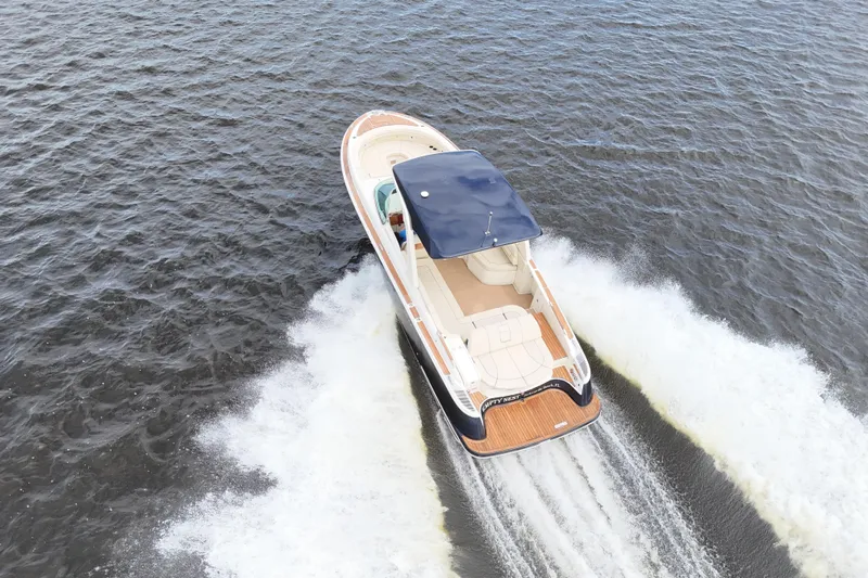  Yacht Photos Pics 2020 Chris-Craft Launch 31 GT cruising on open water, aerial view.