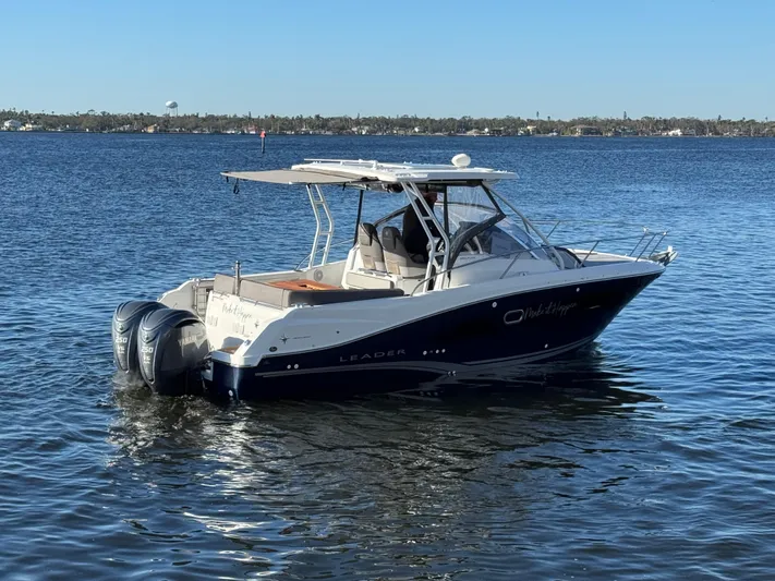 Make It Happen Yacht Photos Pics 2022 Jeanneau Leader 9.0 WA boat on calm water, featuring twin outboard engines.
