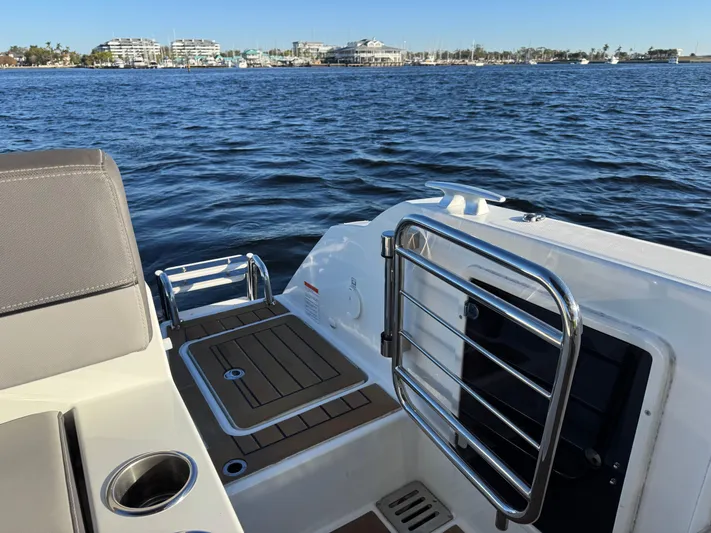 Make It Happen Yacht Photos Pics 2022 Jeanneau Leader 9.0 WA boat deck with ocean view and marina backdrop.
