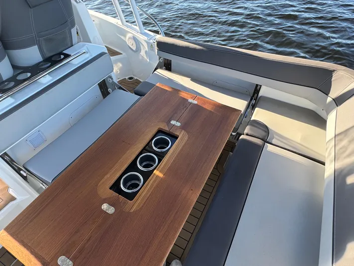 Make It Happen Yacht Photos Pics Jeanneau Leader 9.0 WA 2022 boat interior with wooden table and seating.