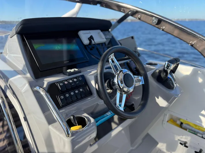 Make It Happen Yacht Photos Pics 2022 Jeanneau Leader 9.0 WA helm with modern controls and steering wheel.
