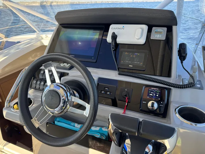 Make It Happen Yacht Photos Pics 2022 Jeanneau Leader 9.0 WA helm with Garmin navigation system and steering wheel.