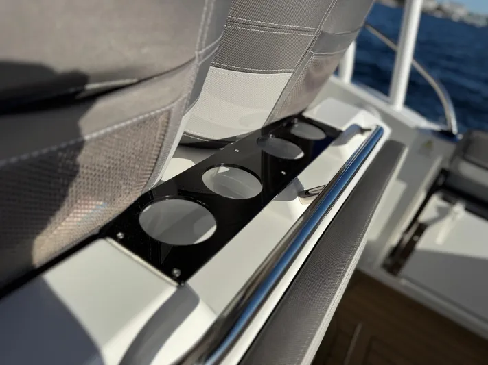 Make It Happen Yacht Photos Pics 2022 Jeanneau Leader 9.0 WA boat interior with cup holders and seating.