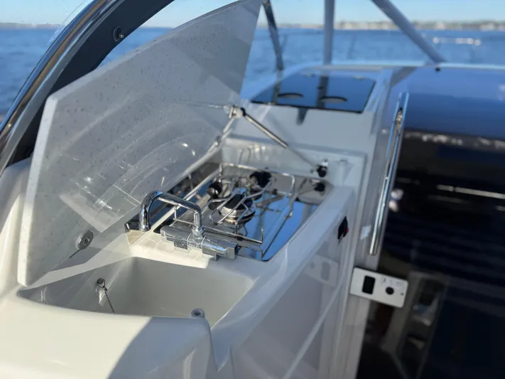 Make It Happen Yacht Photos Pics Jeanneau Leader 9.0 WA 2022 boat kitchen with stove and sink, ocean view.