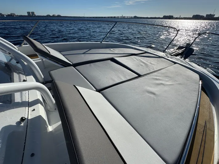 Make It Happen Yacht Photos Pics 2022 Jeanneau Leader 9.0 WA boat with sunbathing deck on calm water.