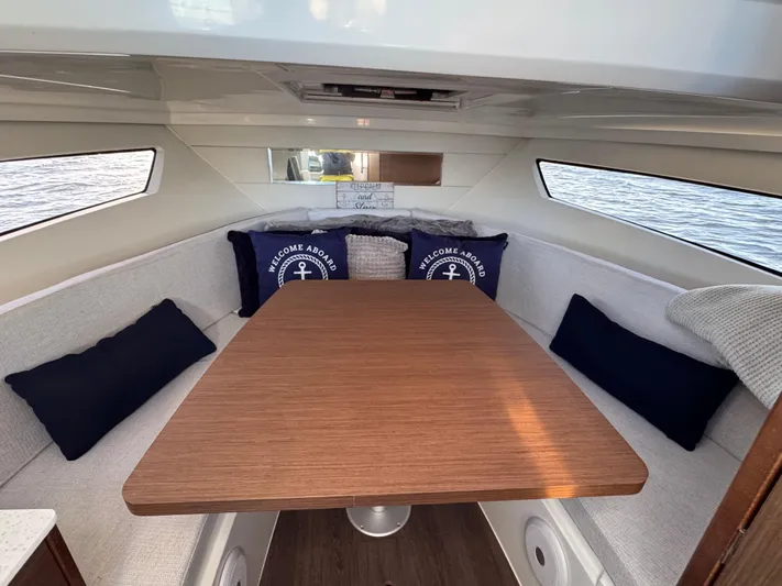 Make It Happen Yacht Photos Pics Interior of 2022 Jeanneau Leader 9.0 WA boat with cozy seating and nautical decor.