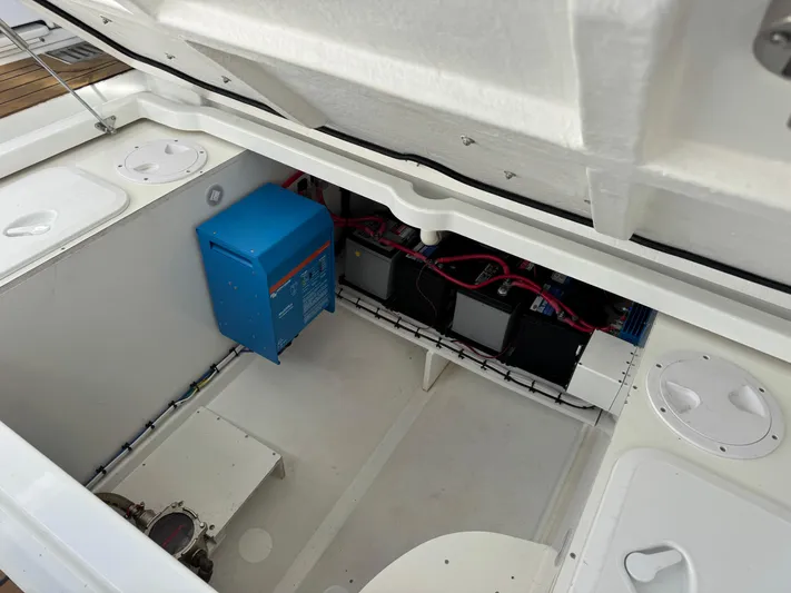 Make It Happen Yacht Photos Pics 2022 Jeanneau Leader 9.0 WA engine compartment with batteries and electrical components.