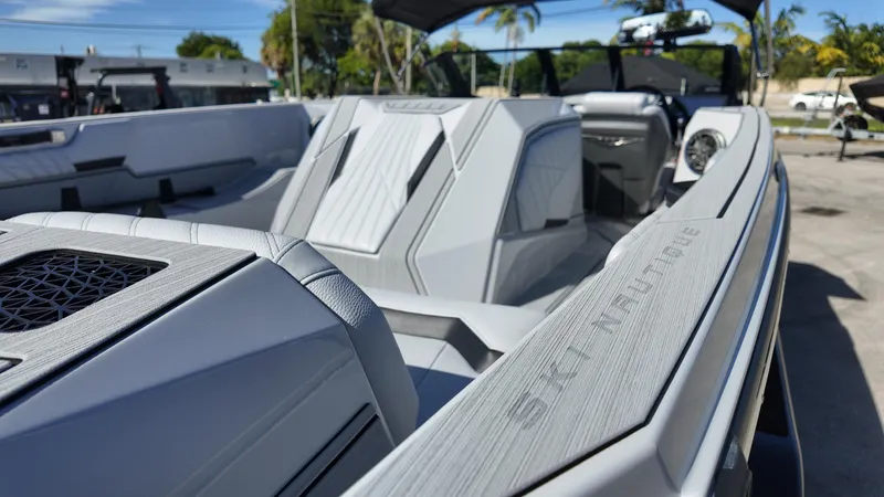  Yacht Photos Pics 2026 Nautique Ski boat interior with sleek, modern design and luxurious seating.