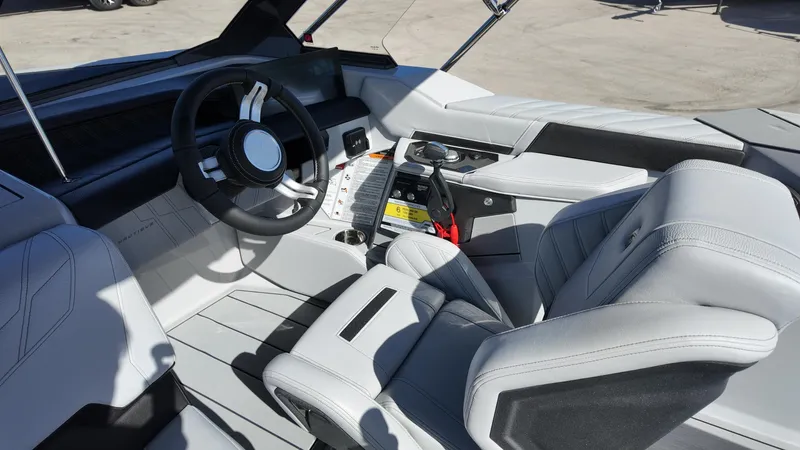  Yacht Photos Pics 2026 Nautique Ski boat interior with modern steering wheel and sleek seating design.