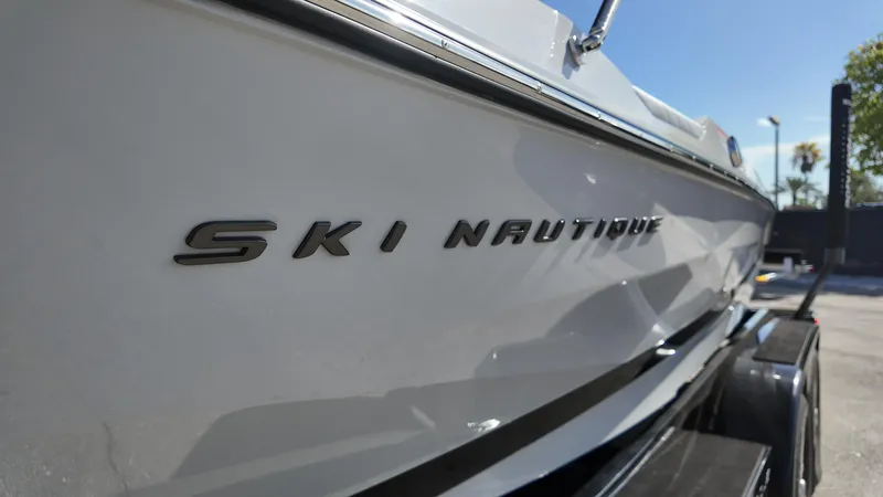  Yacht Photos Pics 2026 Nautique Ski boat side view with logo in sunlight.