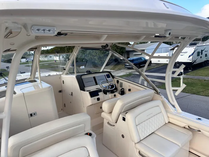 Sweet Life Yacht Photos Pics 2019 Grady-White Freedom 325 boat interior with helm, seating, and navigation equipment.
