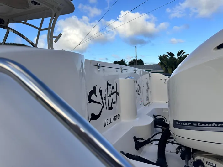 Sweet Life Yacht Photos Pics 2019 Grady-White Freedom 325 boat with outboard motor, clear sky background.