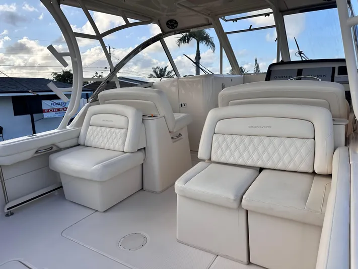 Sweet Life Yacht Photos Pics 2019 Grady-White Freedom 325 boat interior with white cushioned seating.