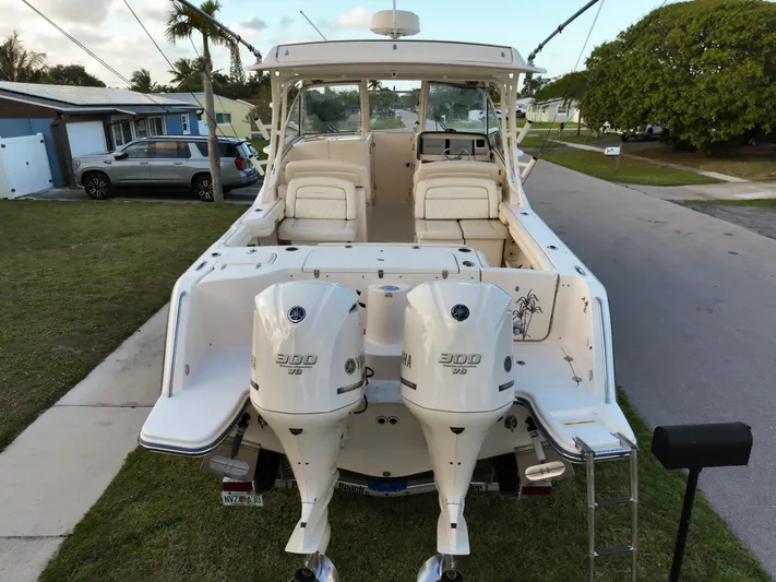 Sweet Life Yacht Photos Pics 2019 Grady-White Freedom 325 boat with dual Yamaha 300 engines, parked on a residential street.