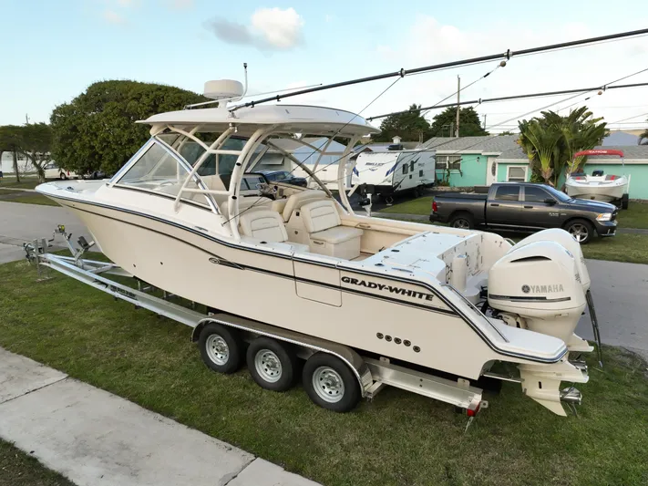 Sweet Life Yacht Photos Pics 2019 Grady-White Freedom 325 boat on trailer, parked outdoors, featuring Yamaha engines.