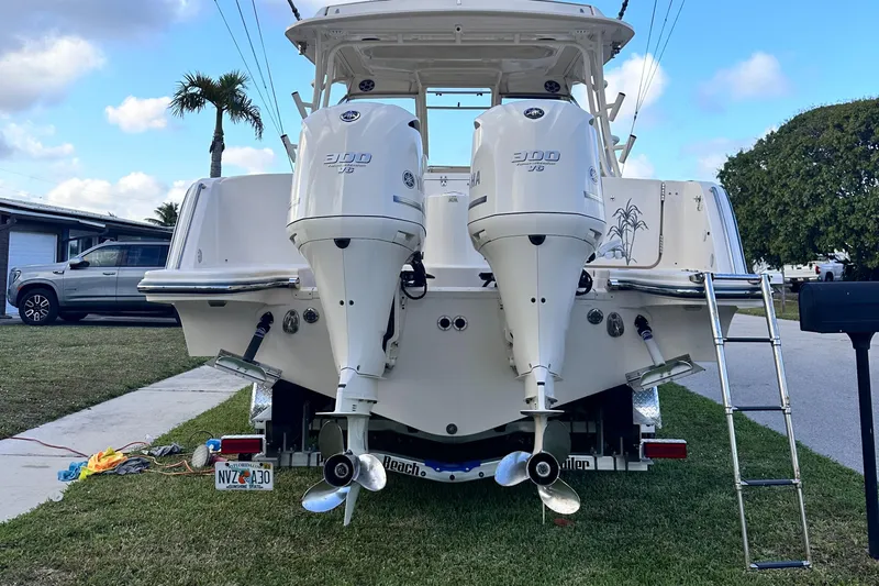 Sweet Life Yacht Photos Pics 2019 Grady-White Freedom 325 boat with dual outboard engines, parked on grass.