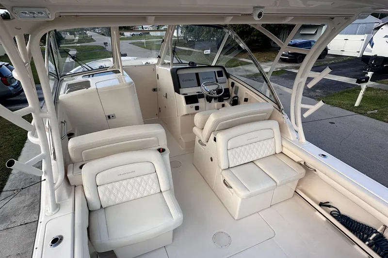Sweet Life Yacht Photos Pics 2019 Grady-White Freedom 325 boat interior with white seating and helm station.