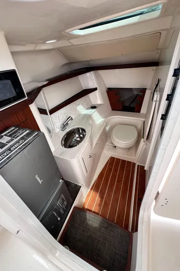 Sweet Life Yacht Photos Pics 2019 Grady-White Freedom 325 boat interior with compact bathroom and wooden flooring.