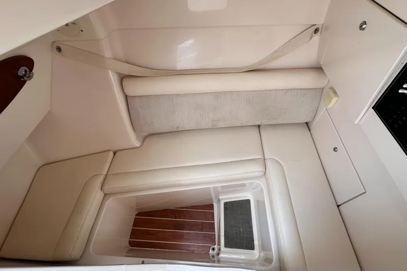 Sweet Life Yacht Photos Pics 2019 Grady-White Freedom 325 cabin interior with cushioned seating and wooden flooring.